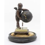 An early 20th century bronze mantel clock with putto supporting a globe on onyx base, 17.5cm high,