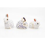 Three boxed Royal Crown Derby paperweights gold stoppers Rabbits.