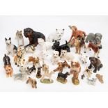 An extensive collection of bone china and resin models of dogs, varying breeds to include: