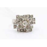 A diamond and white metal cluster ring, the central claw set round brilliant cut of approx. 0.35ct