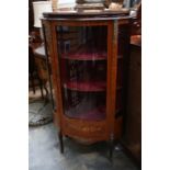 A French style rosewood veneered marquetry inlaid display cabinet, brass mounted, fitted with a