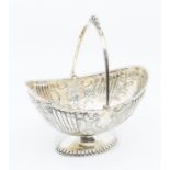 A late Victorian silver boat shaped sugar basket, chased fluted, floral and geometric decoration,