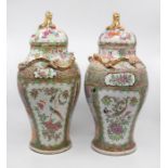A pair of 19th Century Canton famille rose large baluster jars and covers, each cover wilt gilt