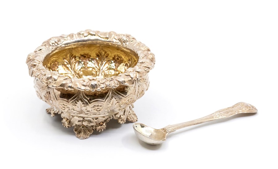 A George IV silver-gilt large circular salt, border and body chased with flowers and foliage, on