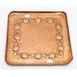 An Arts & Crafts Newlyn hand hammered copper tray, square shaped, embossed decoration to border of