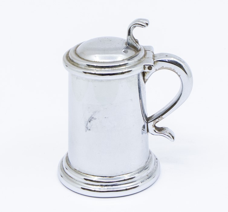 A Dunhill novelty plated table lighter modelled as tankard, shell thumbpiece, C-scroll handle, 9cm