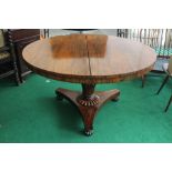 An early 19th Century rosewood circular tilt top breakfast table, circa 1830, raised on a turned