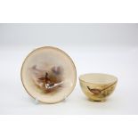 A Royal Worcester circular pin dish with foot rim, shape no: 2769, the body painted with a pair of