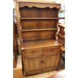 A traditional oak dresser and rack, the rack with two plate shelves, the base section with two