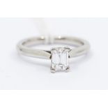 An emerald cut diamond and platinum ring, comprising a claw set emerald cut diamond weighing approx.