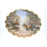 A large porcelain scallop edge shaped oval dish with gilt band, the entire body painted with
