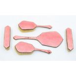 A 1930s white metal and pink enamel dressing table set.