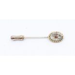 A Victorian 9ct gold and diamond set pin, the oval form star set with  arose cut diamond, rope
