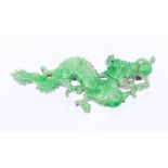 A carved jade and white metal brooch in the form of a dragon, length approx 80mm, pin and roller