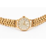 A ladies 14ct gold Doxa wristwatch, round silvered dial, approx. 18mm, applied rose tone baton