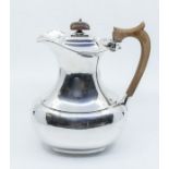 A George V plain silver hot water jug, fruitwood handle and finial, hallmarked by F C Richards,