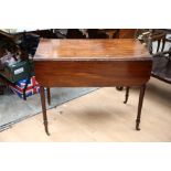 An early 19th Century mahogany Pembroke table, fitted with a single drawer, raised on turned legs