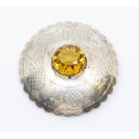 A Scottish plaid brooch, circular form, claw set to the centre with a faceless round cut glass,