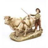 A Royal Dux Bohemia figural group of a young farmer boy herding cattle, stamped 837 to underside,
