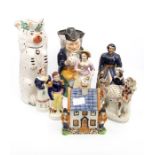 Staffordshire figures including Toby jugs and money box, all 19th Century,