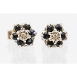 A pair of diamond and sapphire stud earrings, floral clusters set with a small illusion set