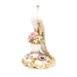 A Royal Crown Derby porcelain model of a Peacock, 19th Century style, the peacock perches on a