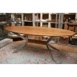 A Hulsta teak veneered oval topped dining table, steel frame support structure, measuring 75cm high,