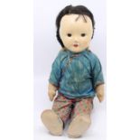 A 1950's Chinese doll with original clothes
