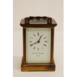 A mid 20th Century brass Carriage Clock, with white enamel dial having Roman numerals and