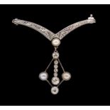 An Edwardian diamond and pearl set platinum and gold brooch, comprising an engraved wish bone shaped