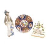 A Coalport 'Park Lodge' cottage model, a Casades figure of a boy and cat, a 1970's Japanese plate.