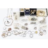 A collection of silver and white metal jewellery to include stone set pendants, chains, rings,
