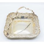 A late Victorian shaped square serving basket, the sides profusely chased with flower, shaped