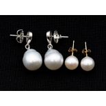 A pair of of cultured South sea pearl and silver earrings, comprising a pear shaped silver top
