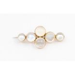An early 20th century moonstone 9ct gold brooch , comprising six cabochon moonstones of graduated
