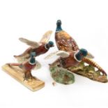A group of four Beswick Pheasants, two walking, two in flight - model numbers include: 1225; 1774,