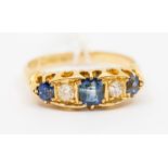 A Victorian sapphire and diamond 18ct gold ring, comprising a central oval sapphire set either