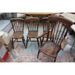 A late 19th early 20th Century oak spindle back armchair with three other oak kitchen chairs (4)