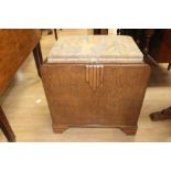 An Art Deco oak dressing table box stool, the padded seat opening to reveal a single storage