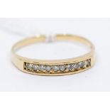 A yellow metal diamond set half eternity ring, probably 14ct gold, set with 10 individually set