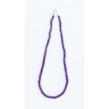 A amethyst and silver bead necklace, comprising off round faceted beads, length approx 16''