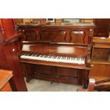 A Harrison upright piano, having seven octaves with sustain and damper pedals, panelled case,
