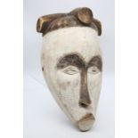 An African Tribal mask, female head with head dress, white heightening  Provenance: from a Private