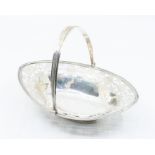 A George III silver bright-cut engraved navette shaped small basket, reeded rim and swing handle,