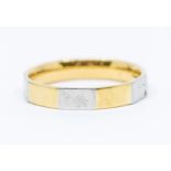 A two tone 18ct gold ring, comprising flat facets of alternate yellow and white gold, width approx