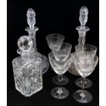 A pair of 19th Century style facet cut decanters and stoppers; a cut glass spirit decanter