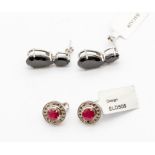 A pair of ruby and diamond silver earrings, round form each set to the centre with round cut claw