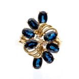 A sapphire and diamond set 14ct gold cluster ring, comprising an elongated form claw set with oval