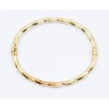 A 14ct gold bracelet, spiral twist form, hinged, internal diameter approx 60mm, weight approx 9.3gms