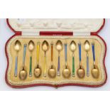 A harlequin set of twelve George V silver gilt and peacock enamel teaspoons, Glasgow, 1912, maker'